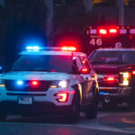 Horrifying Discovery: Stowaway Found Dead Police car and ambulance with flashing lights nighttime