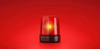 Red emergency light on solid red background