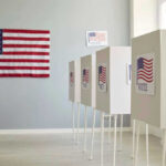 Polling booths with American flags and Vote signs