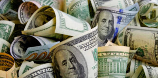 Rolled US dollar bills in various denominations