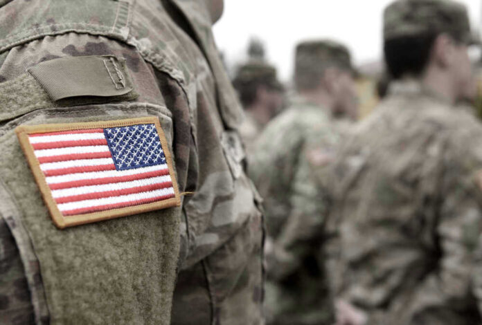 U.S. soldiers in camouflage uniforms with American flag patch