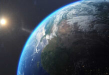 Earth from space with sun in background.