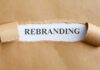Torn paper revealing the word REBRANDING