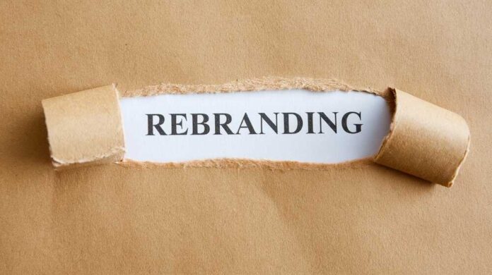 shutterstock_2558685151.jpg Torn paper revealing the word REBRANDING