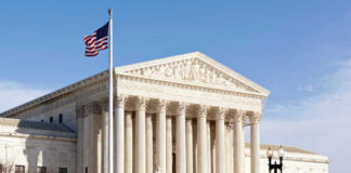 US Supreme Court building with American flag