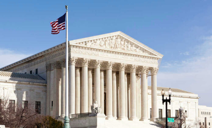 US Supreme Court building with American flag