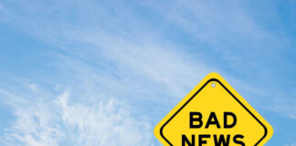 Yellow sign reads bad news in sky