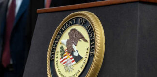Department of Justice seal on a podium.