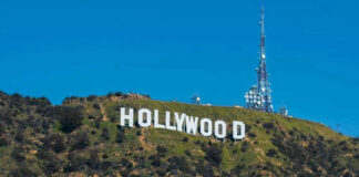 Hollywood sign on a green mountain hillside.