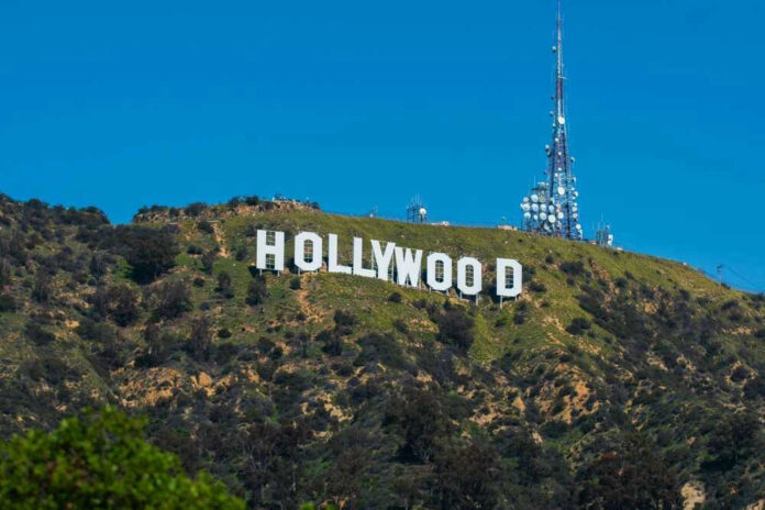 Hollywood sign on a green mountain hillside.