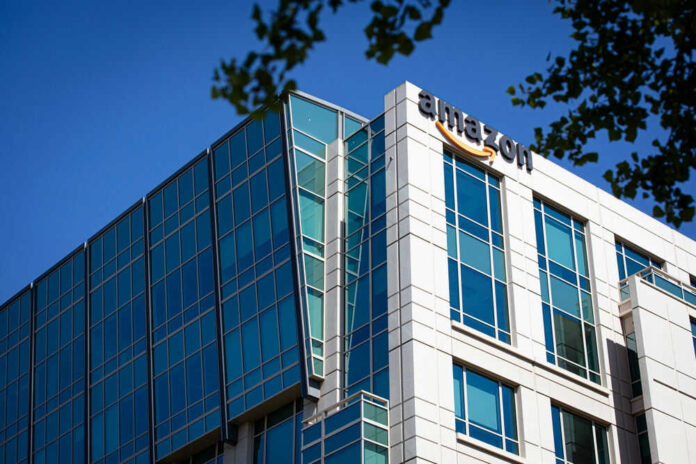 Modern office building with Amazon logo against sky