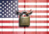 A padlock placed on a background of the American flag