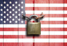 A padlock placed on a background of the American flag