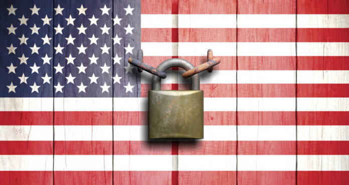 A padlock placed on a background of the American flag