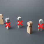 Job Axe Hits: 30,000 Jobs At THIS Comapny?! Wooden figures representing people with red crosses indicating exclusion