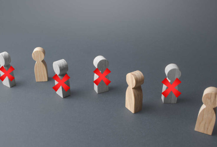 Wooden figures representing people with red crosses indicating exclusion
