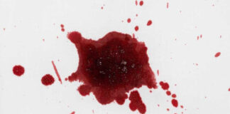 Red liquid splatter on a white background.