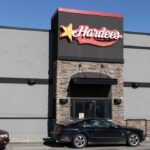 Hardee’s Declares War on Fake Breakfast Exterior view of a Hardee's restaurant with a black car parked in front