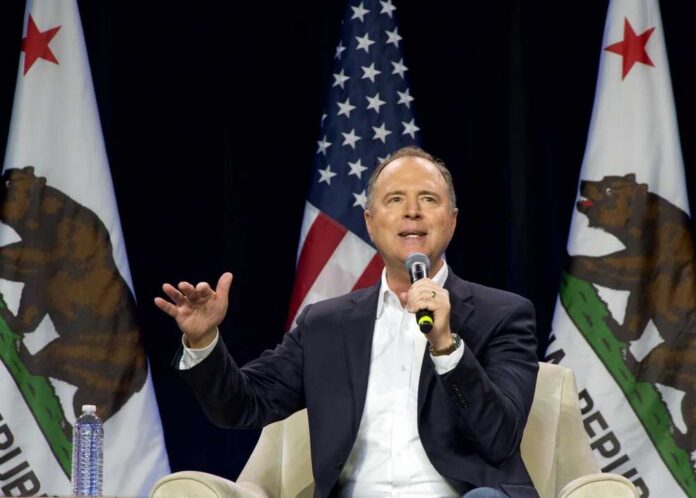 shutterstock_2391489013.jpg A speaker addressing an audience with California flags in the background