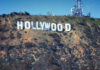 Hollywood sign on hillside with communication towers.
