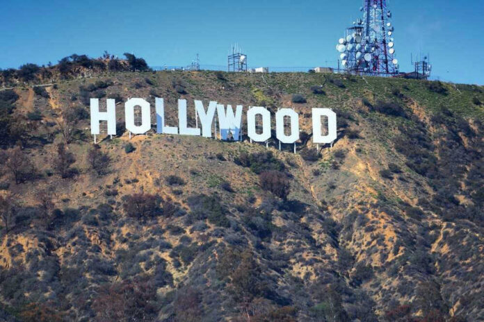 Hollywood sign on hillside with communication towers.
