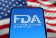 FDA U-Turn Stuns Concerned Americans FDA logo displayed on a smartphone with an American flag background