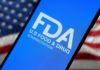 FDA logo on smartphone American flag background