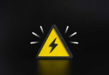 A yellow triangular warning sign with a lightning bolt on a black background