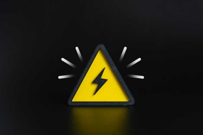 A yellow triangular warning sign with a lightning bolt on a black background