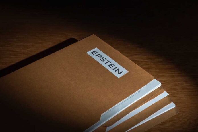 shutterstock_2741629691.jpg Stack of brown file folders with a label reading 'EPSTEIN'