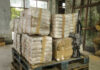 Chase Forces STUNNING Cocaine Dump Stacked packages wrapped in plastic next to a rifle in a warehouse setting