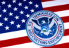 US Immigration and Customs Enforcement badge on flag