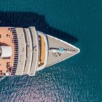 Aerial view of a cruise ship's deck with sun loungers and a pool