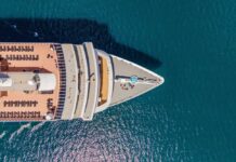 Aerial view of a cruise ship's deck with sun loungers and a pool