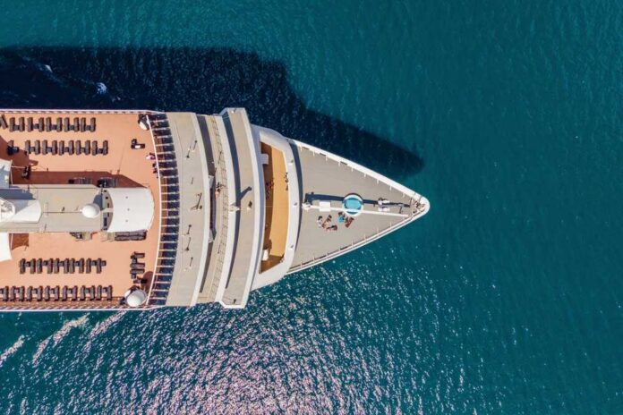 Aerial view of a cruise ship's deck with sun loungers and a pool