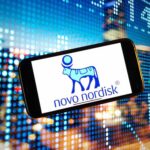 Novo Nordisk DROPS Weight Loss Meds Lawsuit Smartphone displaying the Novo Nordisk logo against a colorful digital background