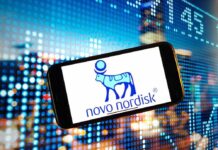 Smartphone displaying the Novo Nordisk logo against a colorful digital background