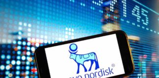 Smartphone displaying the Novo Nordisk logo against a colorful digital background