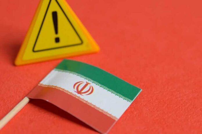 Iranian flag next to a caution sign on a red background