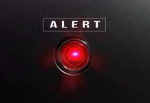 ALERT: Undercover Cop Ambushed Red alert light against black background, text ALERT.