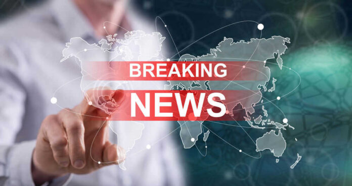 Breaking news graphic over world map background.