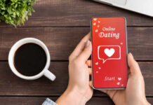 Person holding a smartphone displaying an online dating app