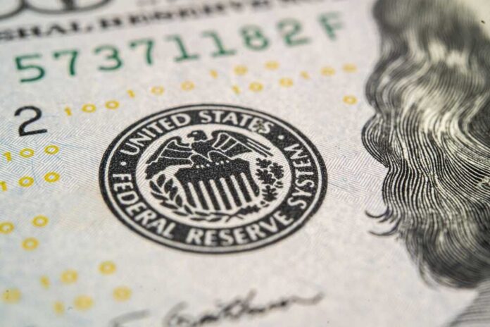 shutterstock_2320128671.jpg Close-up of a United States dollar bill featuring the Federal Reserve emblem
