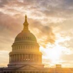 The Capitol building in Washington D.C. silhouetted against a sunset