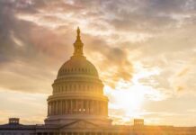 The Capitol building in Washington D.C. silhouetted against a sunset
