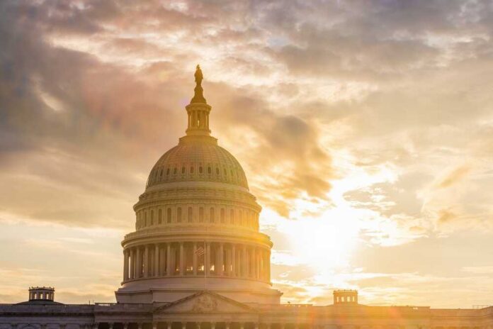 The Capitol building in Washington D.C. silhouetted against a sunset