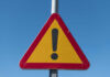 Deadly Crash Shocks U.S. – Many Casualties Triangular warning sign with exclamation mark.
