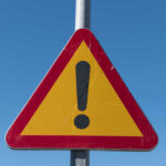 Deadly Crash Shocks U.S. – Many Casualties Triangular warning sign with exclamation mark.