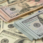 Bombshell Proposal: Slash Taxes for Half of America!? Stacks of US dollars featuring Benjamin Franklin and Ulysses S. Grant.