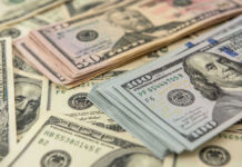 Bombshell Proposal: Slash Taxes for Half of America!? Stacks of US dollars featuring Benjamin Franklin and Ulysses S. Grant.